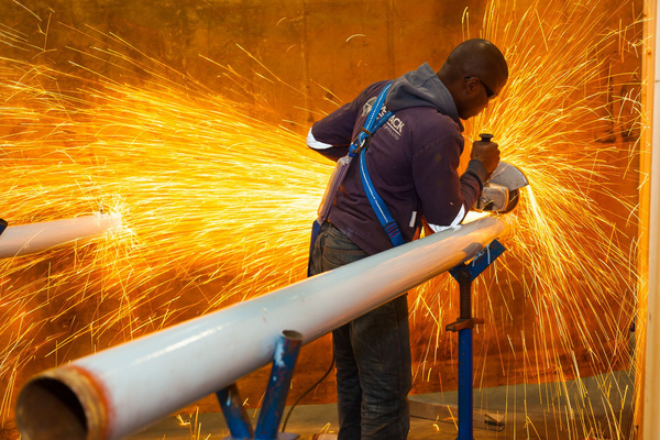 Industrial Photo of a worker grinding and sparks flying. NightOwl Media, Corporate Photography. Photographer based in Pretoria & Johannesburg, Gauteng, South Africa. Videographer, Marketing, Incentive, Medicas, Mining, Hotel, Lodge, Travel, corporate